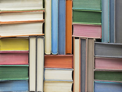 colorful books stacked in various orientations