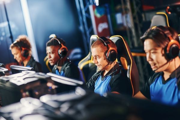 esports team sitting at row of computers wearing headsets